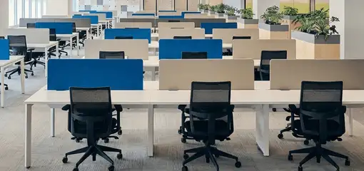 Modern open-plan office space featuring clean workstations, ergonomic chairs, and sanitized carpets provided by professional office cleaning services in Buffalo, NY.