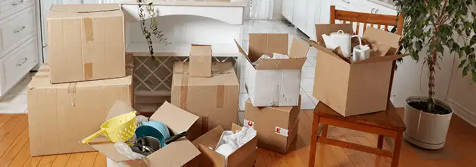 Packed moving boxes and household items in a kitchen before move-out or move-in cleaning, Buffalo, NY.